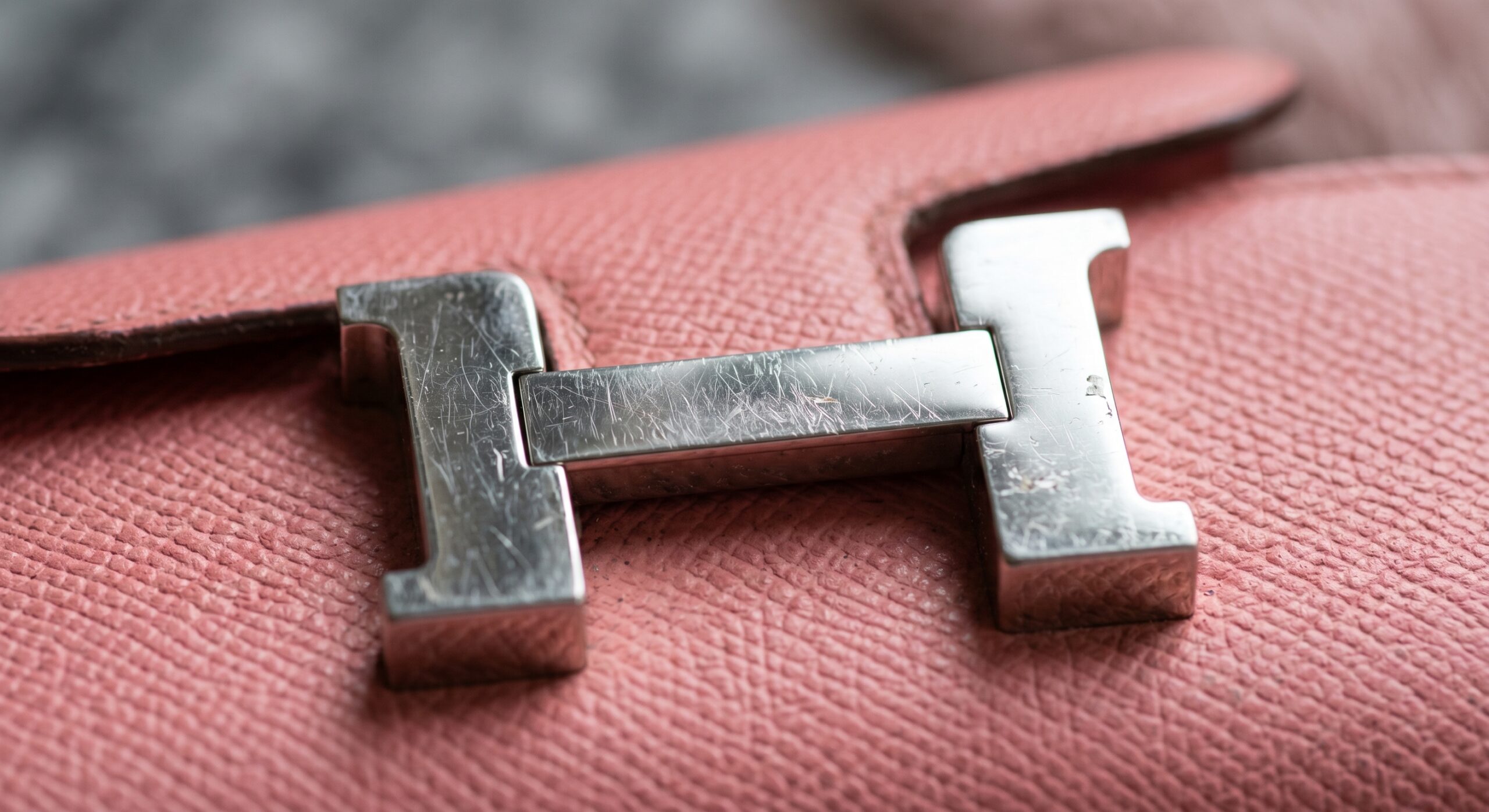 Close-up of the Hermès Constance to Go 'H' buckle, highlighting its vulnerability to scratches